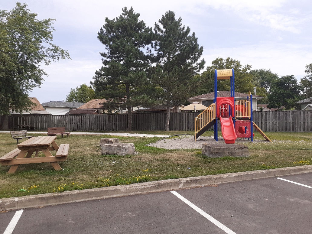 Playground with a picnic table and two benches in view